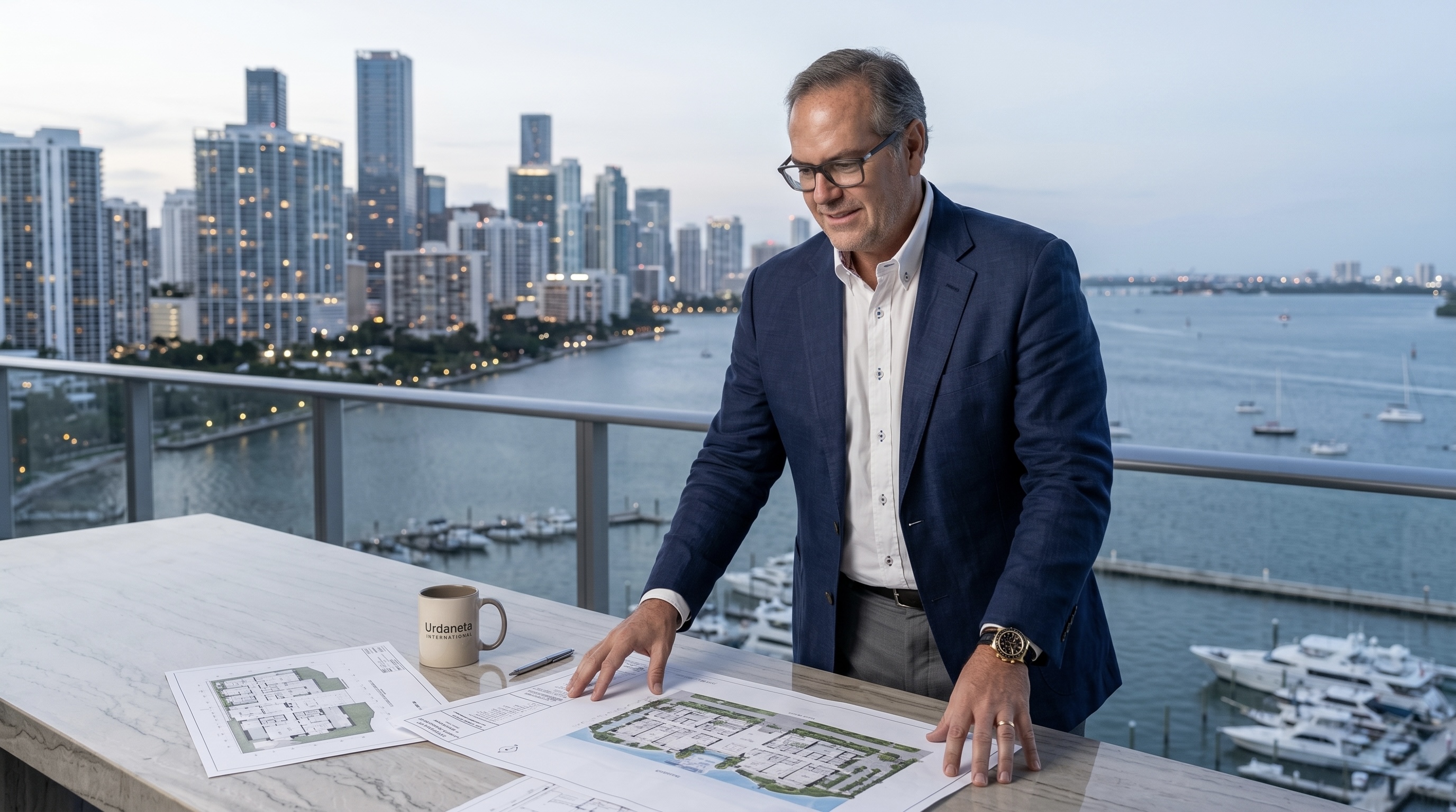 Enrique Urdaneta reviewing property plans with Miami skyline